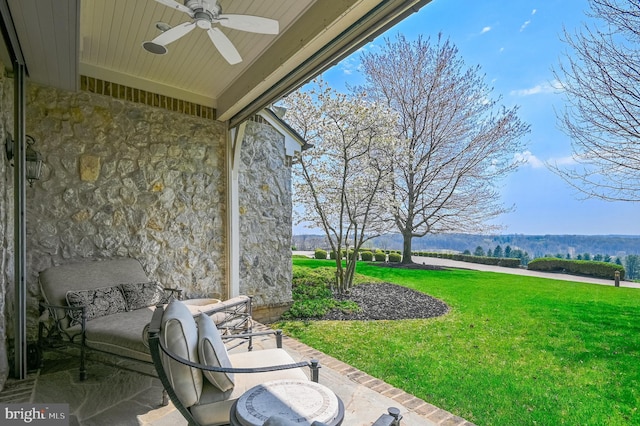 view of patio featuring ceiling fan