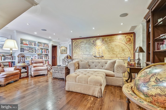 interior space with ornamental molding, wood-type flooring, and built in features