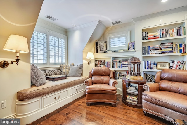 sitting room with crown molding and hardwood / wood-style floors