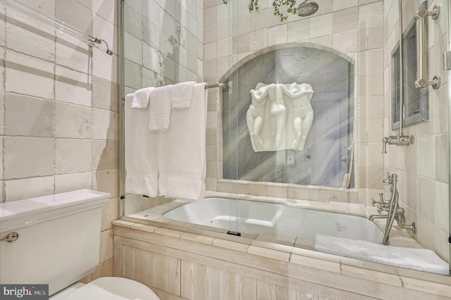 bathroom featuring toilet and tiled shower / bath combo