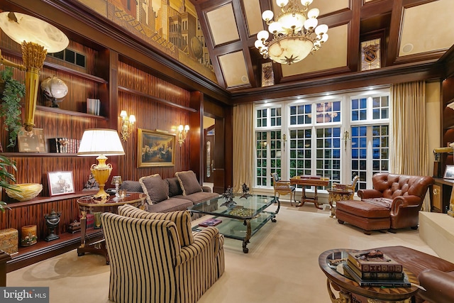 sitting room featuring a notable chandelier, ornamental molding, a high ceiling, and wood walls