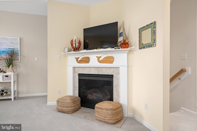 living room featuring carpet flooring and a tiled fireplace