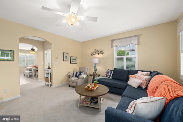 living room with ceiling fan and light colored carpet