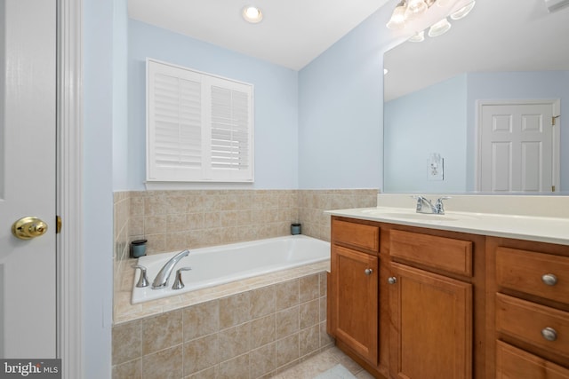 bathroom featuring vanity and a relaxing tiled tub