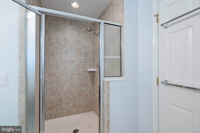 bathroom featuring a shower with shower door