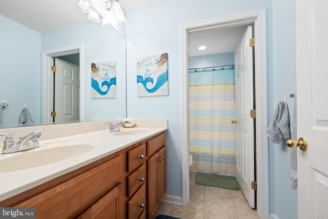 bathroom featuring a shower with curtain, vanity, tile patterned floors, and toilet