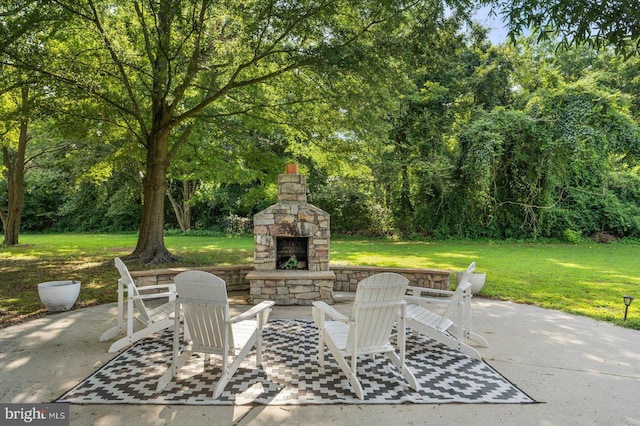 view of patio / terrace featuring an outdoor stone fireplace