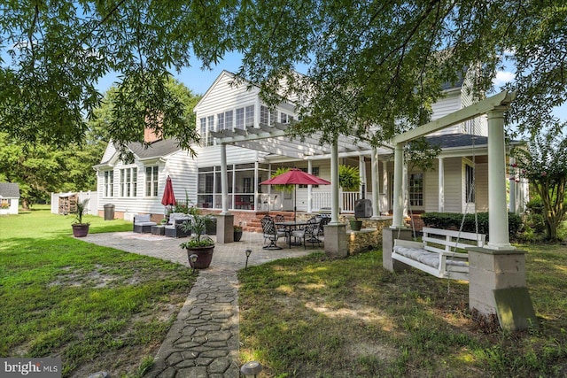 back of property featuring a pergola, an outdoor hangout area, a lawn, and a patio area