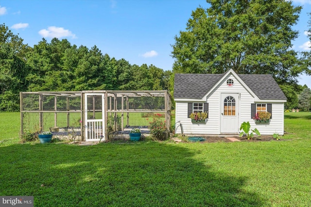 view of outbuilding with a yard