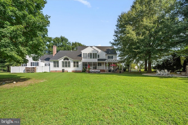 view of front of house featuring a patio, a pergola, and a front yard