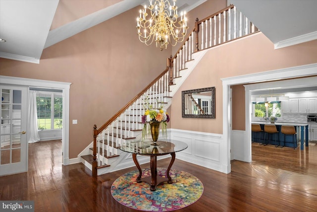 stairway featuring hardwood / wood-style floors, ornamental molding, and a wealth of natural light