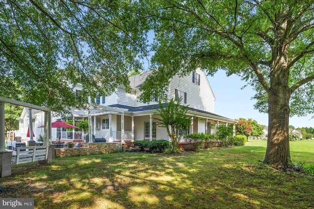 exterior space with a pergola, a front lawn, and covered porch