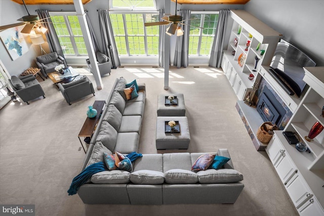 carpeted living room featuring ceiling fan