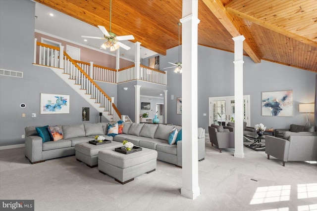 living room featuring ornate columns, light colored carpet, and wood ceiling