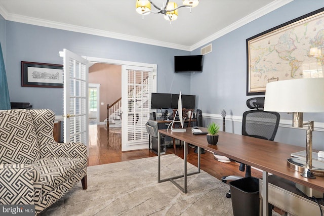 home office with crown molding, an inviting chandelier, and hardwood / wood-style floors