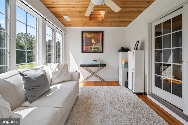 living room with hardwood / wood-style flooring, ceiling fan, and wooden ceiling