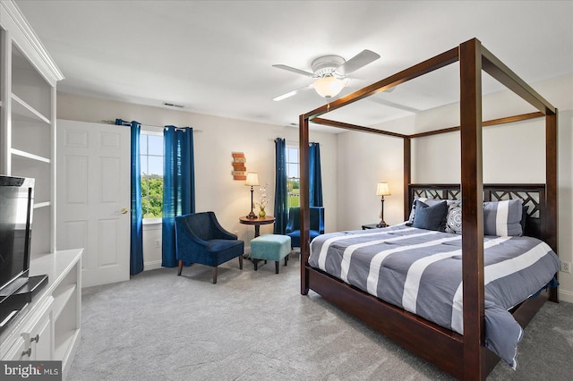 carpeted bedroom with ceiling fan and multiple windows