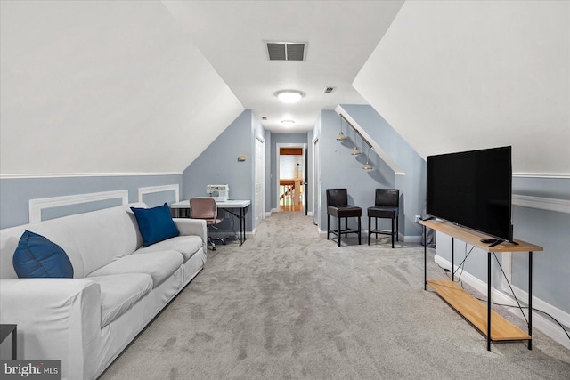 living room featuring lofted ceiling and light colored carpet