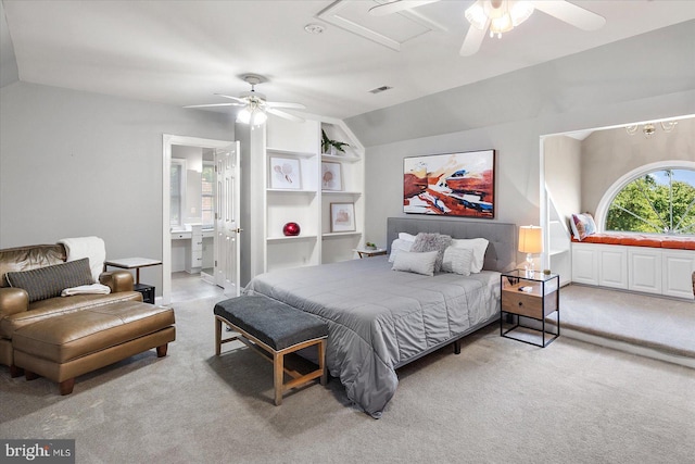 carpeted bedroom featuring lofted ceiling, ensuite bath, and ceiling fan