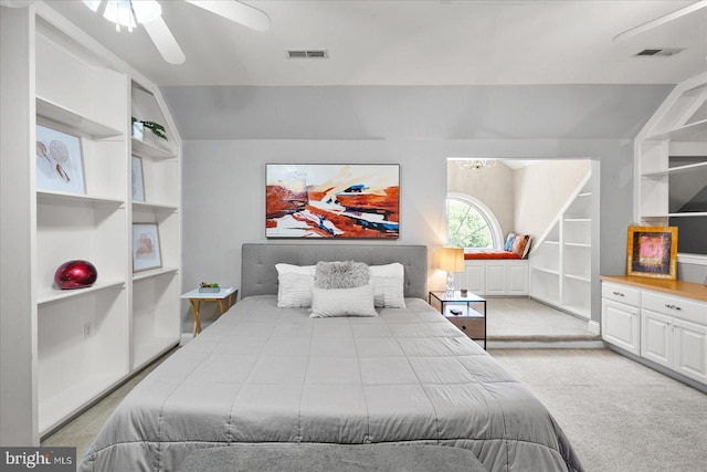 bedroom with ceiling fan, vaulted ceiling, and light carpet