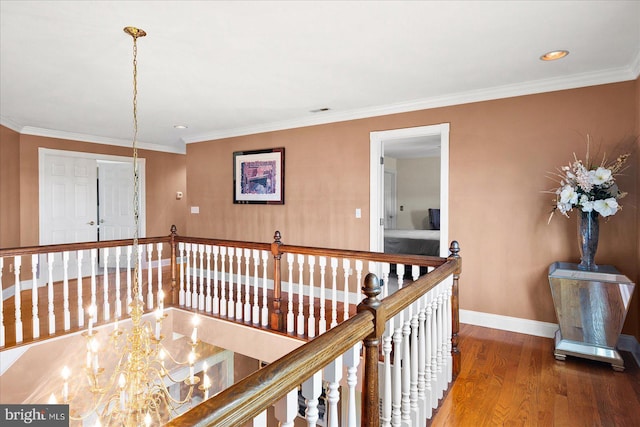 hall with hardwood / wood-style flooring and ornamental molding