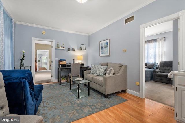 living room with hardwood / wood-style flooring and ornamental molding