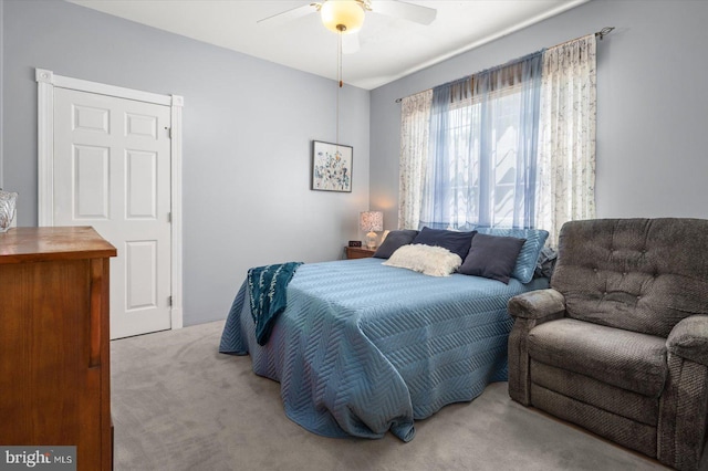 bedroom with light colored carpet and ceiling fan