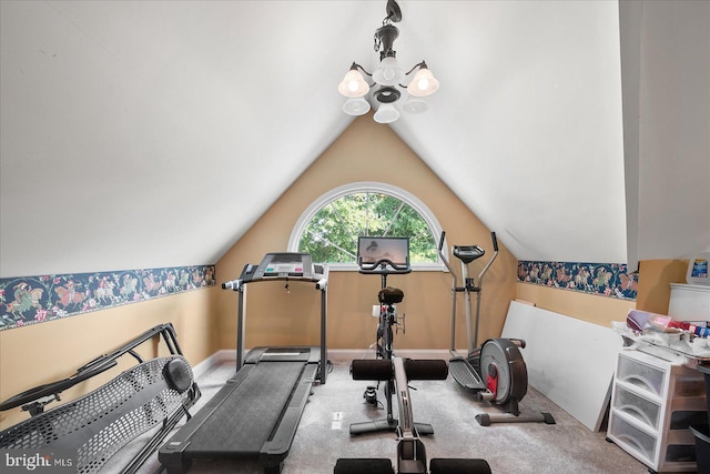 exercise room with lofted ceiling, a chandelier, and carpet floors