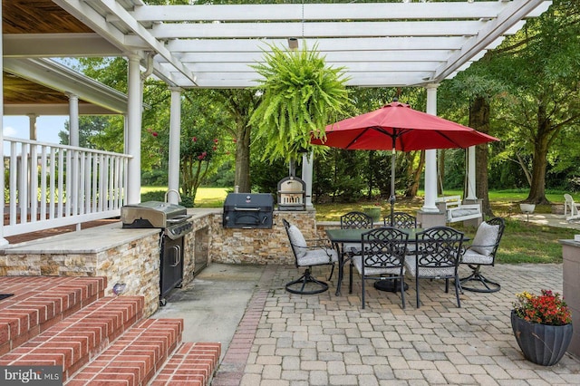 view of patio featuring an outdoor kitchen, a grill, and a pergola