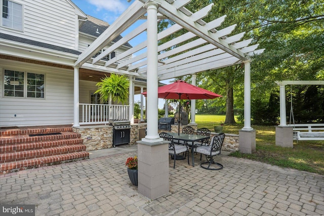 view of patio featuring area for grilling and a pergola