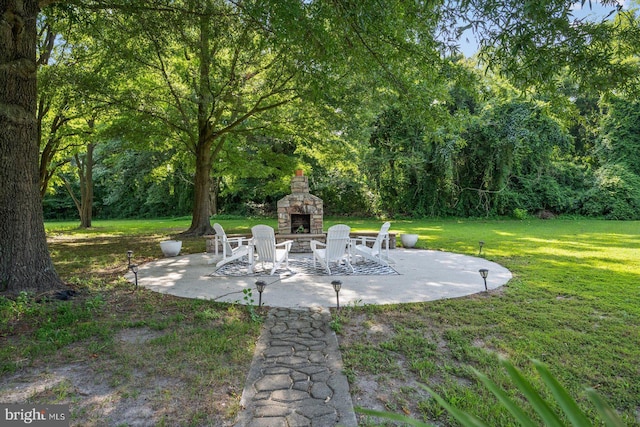 view of patio / terrace featuring an outdoor stone fireplace