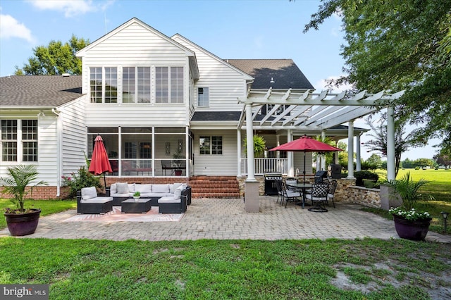 back of property with outdoor lounge area, a pergola, a lawn, and a patio area