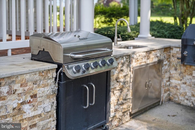 view of patio / terrace with area for grilling and sink