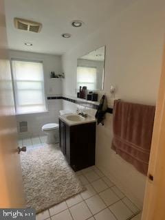 bathroom featuring vanity, tile patterned floors, and toilet