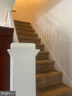 staircase with wood-type flooring