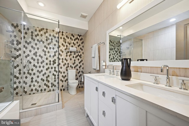 bathroom with tile walls, tile patterned floors, and toilet