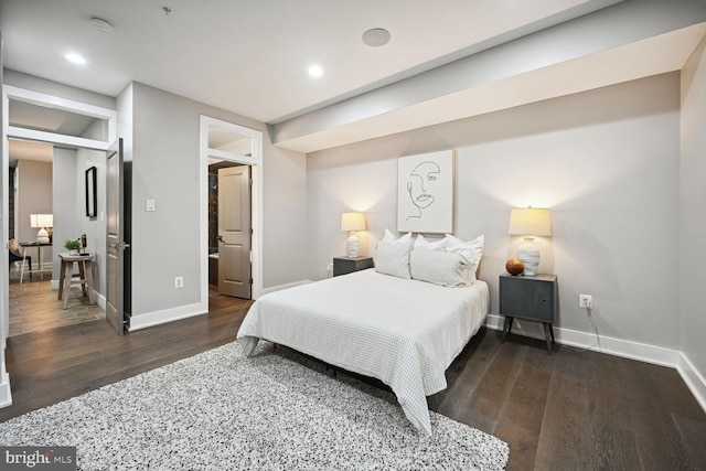 bedroom with dark hardwood / wood-style flooring