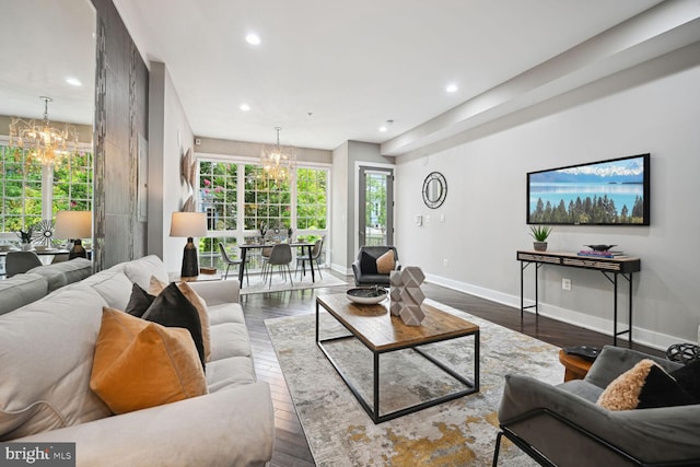 living room with dark wood-type flooring and a chandelier