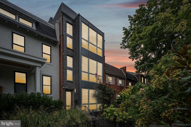 view of outdoor building at dusk