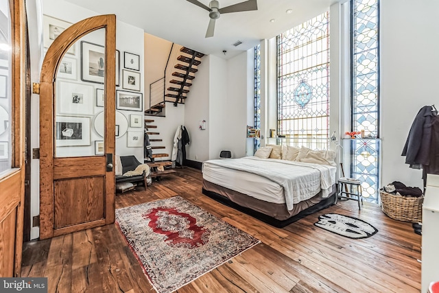 bedroom featuring hardwood / wood-style flooring, ceiling fan, and visible vents