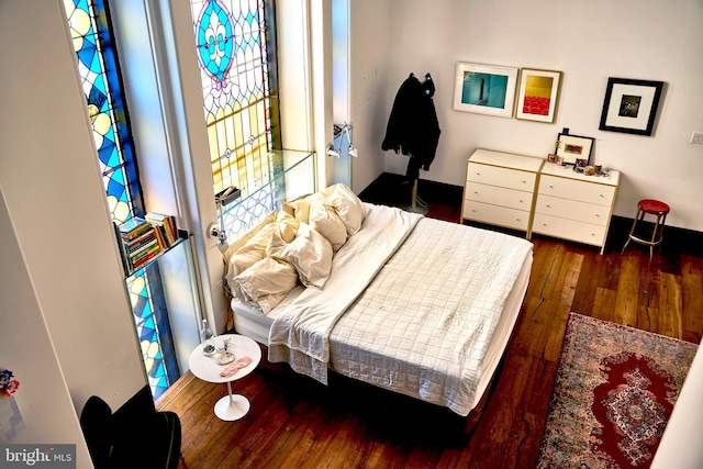 bedroom featuring dark wood-style flooring