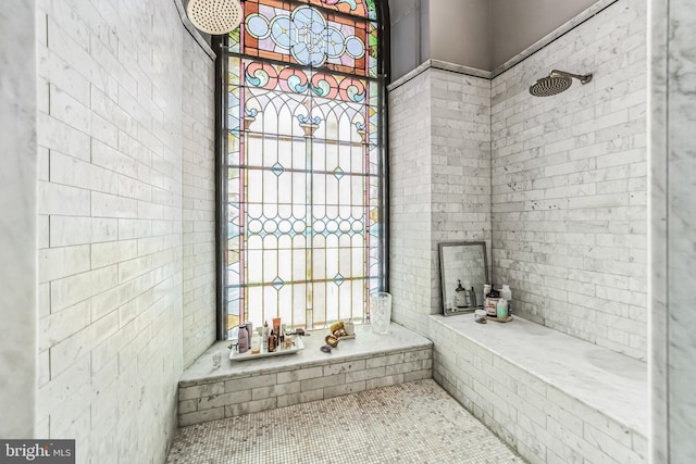 bathroom with a wealth of natural light and tiled shower