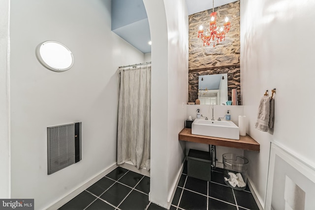 full bathroom featuring baseboards, tile patterned flooring, visible vents, and a sink