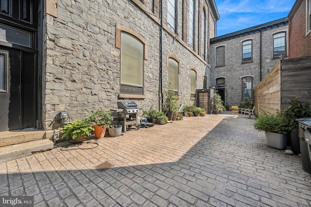 view of patio with entry steps and area for grilling