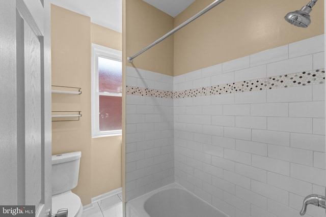 bathroom featuring tile patterned floors, tiled shower / bath, and toilet