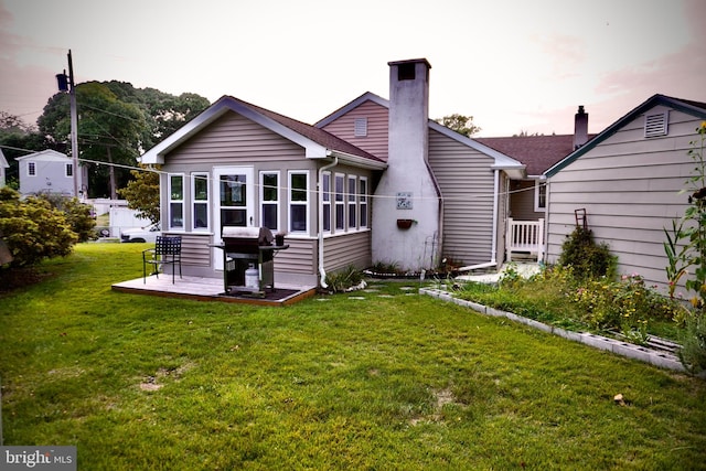 rear view of house featuring a yard