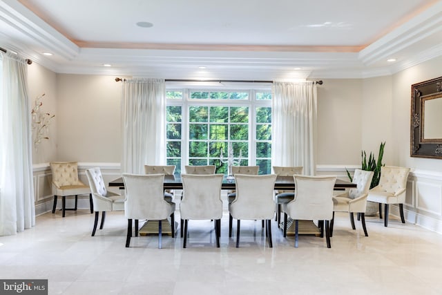 dining area featuring crown molding and a tray ceiling