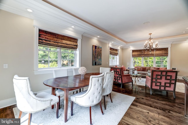 dining space featuring dark hardwood / wood-style flooring, a chandelier, and a healthy amount of sunlight