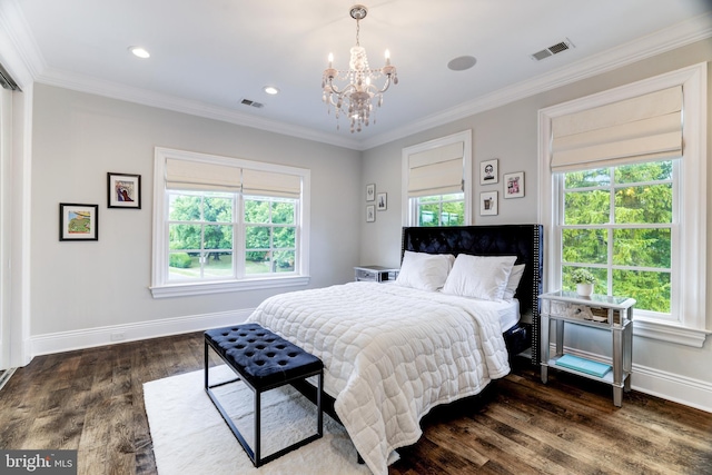 bedroom featuring ornamental molding, dark wood-type flooring, and a chandelier