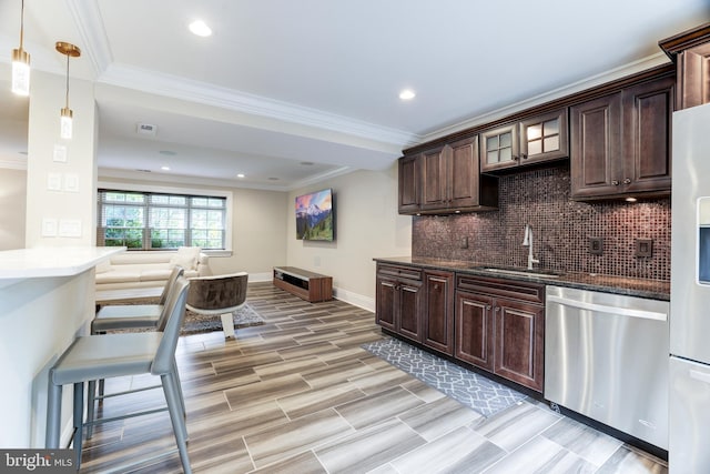 kitchen featuring dishwasher, sink, backsplash, hanging light fixtures, and dark brown cabinetry